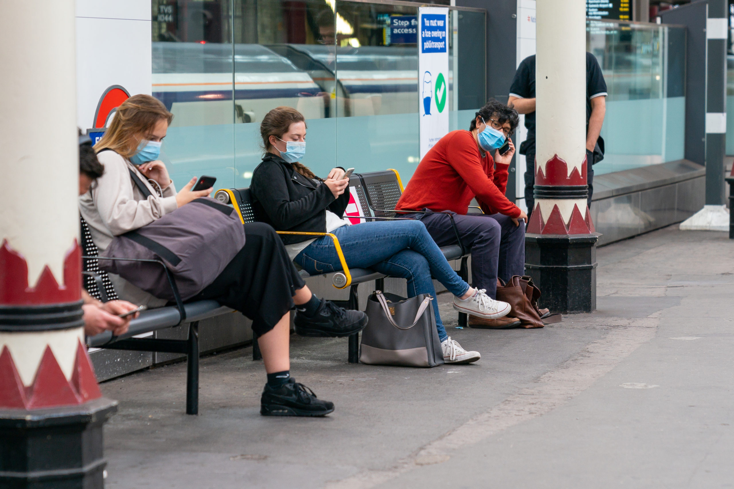 Commuters social distancing in face masks